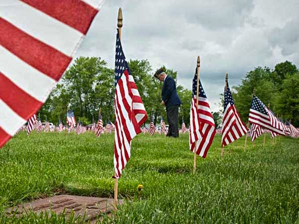 John Hood, honorary commander for Joint Base McGuire-Dix-Lakehurst, has a moment of silence for those burried at at Brig. Gen. William C. Doyle Veterans Memorial Cemetery in Arneytown NJ before the annual State of New Jersey Memorial Day commemoration ceremony. ( RON TARVER / Staff Photographer ) May 24 2014